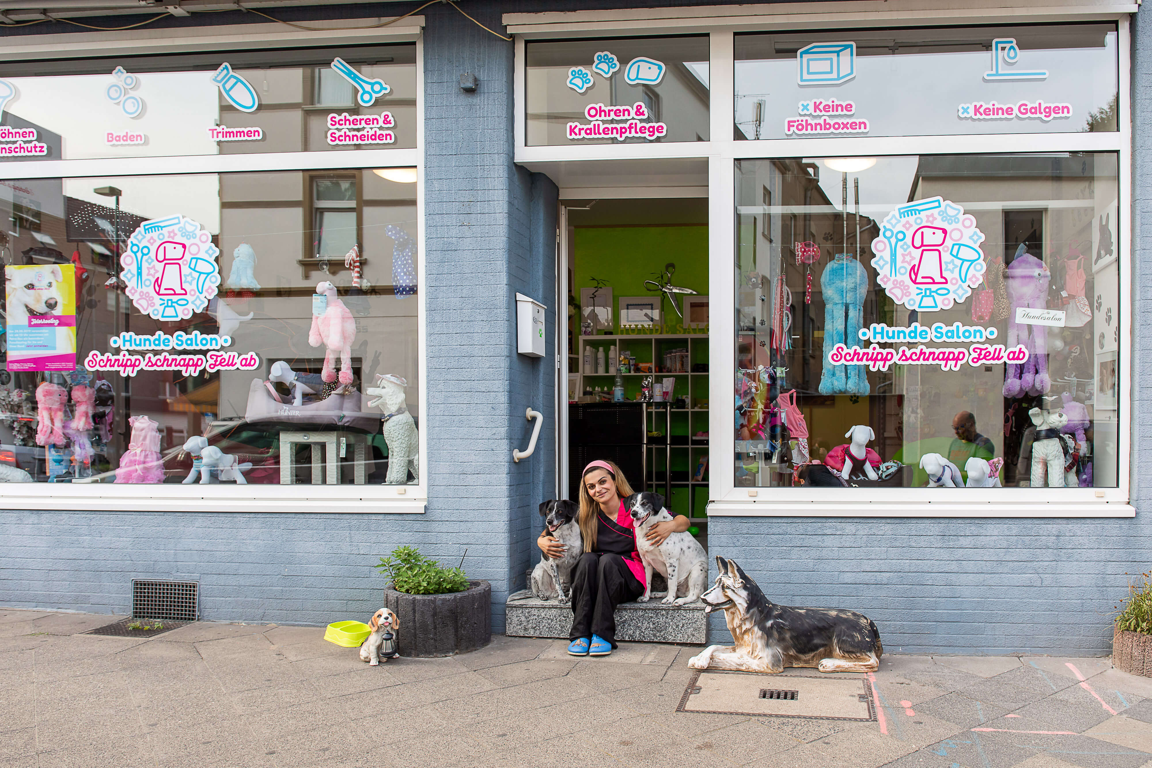 Eine Frau sitzt mit Hunden auf einem Fenstersims bei Schnipp Schnapp Fell Ab
